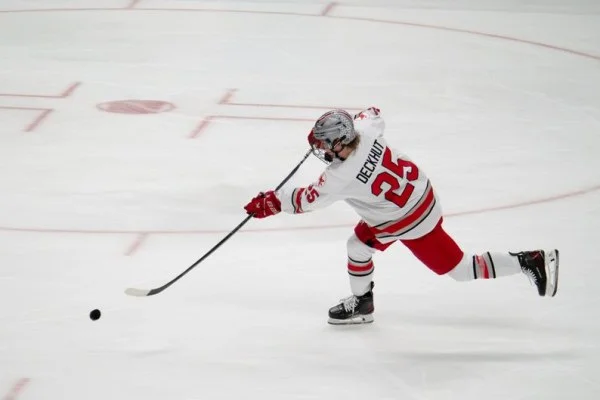 ice hockey player shooting puck